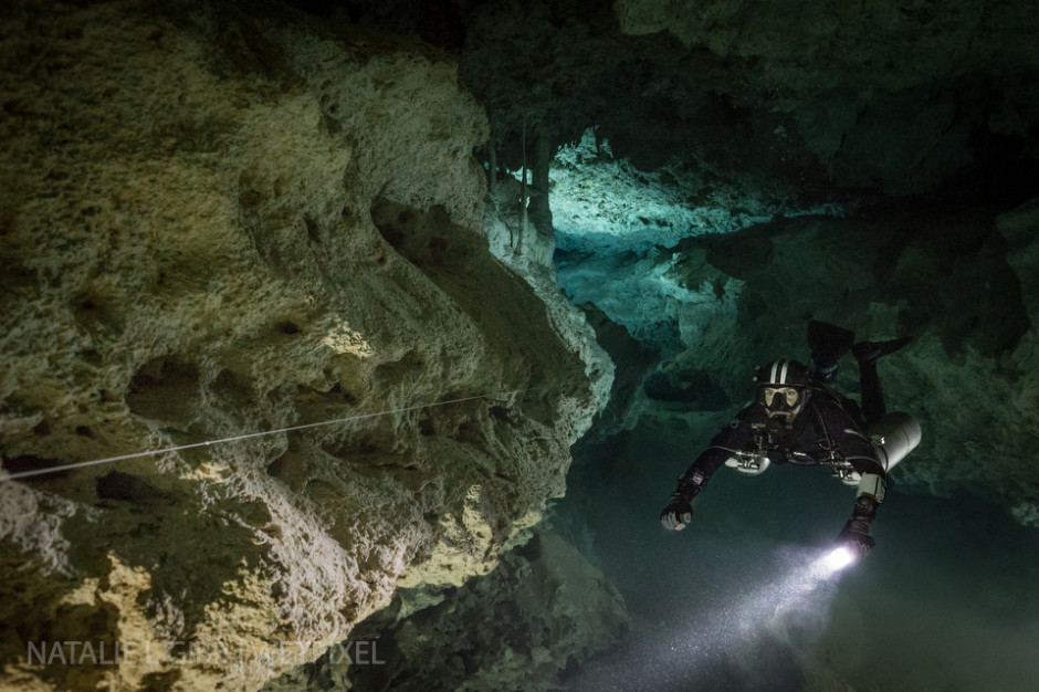 Nicholas White floats in front of a single video light, which adds depth to this canyon shot at Cenote Coop One. 