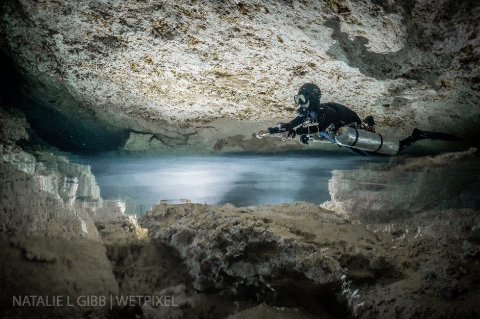 Diver Hana Cho floats above the halocline at Cenote Lunas y Sombras. The halocline is the interface of fresh and salt water, and it looks like an underwater lake. 
