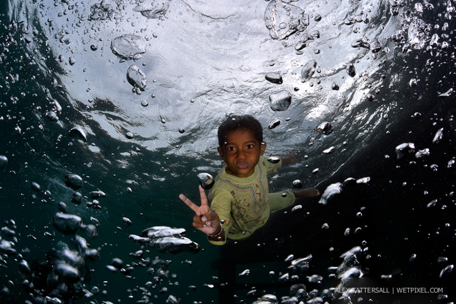 The children of Arborek Island. We arrived at Arborek jetty and conditions were not so good, torrential rain and poor vis, but the children were happily playing and jumping off the jetty for us. Nauticam NA-D750, Sigma 15mm.