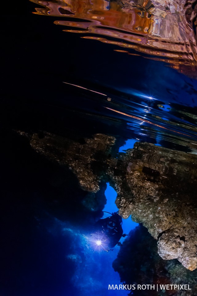 Diver exploring a cave in Wagmab-Farondi,  Misool Area.