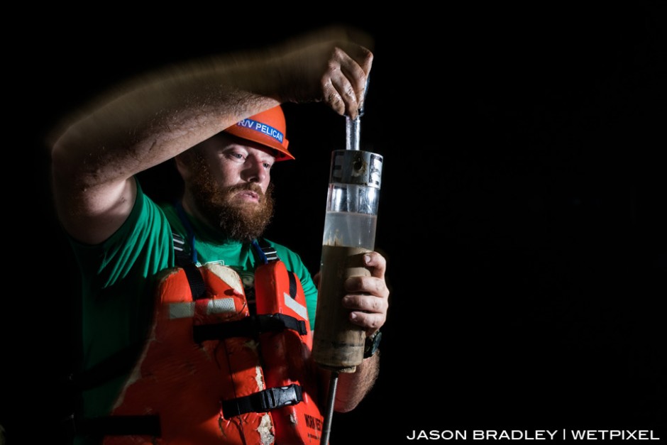 Dr. Cliff Nunnally, scientist for Project Woodfall, preps a core sediment sample from the deep-sea floor for further analysis.